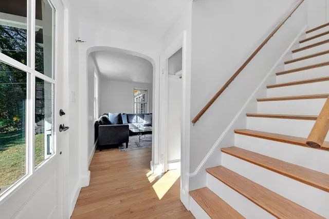 a view of entryway and hall with wooden floor