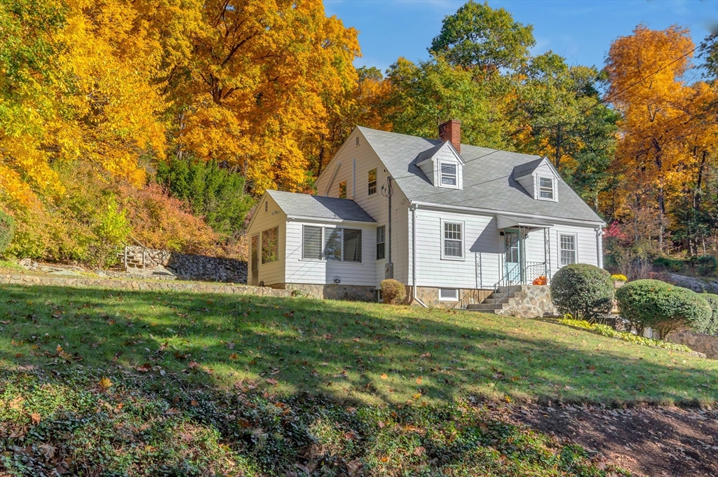 139 High Street Winchester, MA 01890 - Photo 19 of 24 a front view of a house with a yard