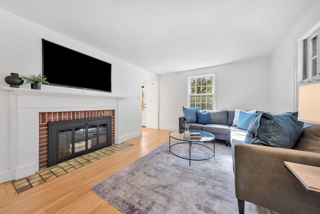 139 High Street Winchester, MA 01890 - Photo 4 of 24 a living room with furniture a flat screen tv and a fireplace