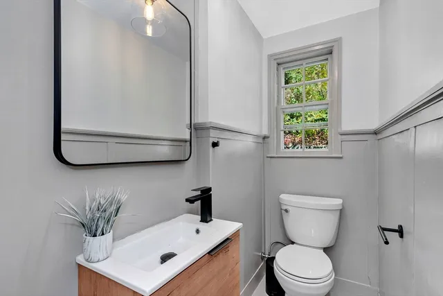 a white toilet sitting next to a bathroom sink