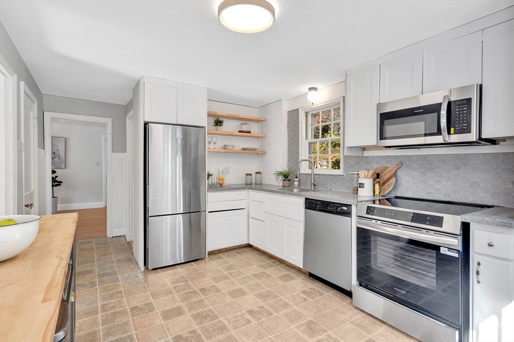 139 High Street Winchester, MA 01890 - Photo 7 of 24 a kitchen with granite countertop a refrigerator stove and sink