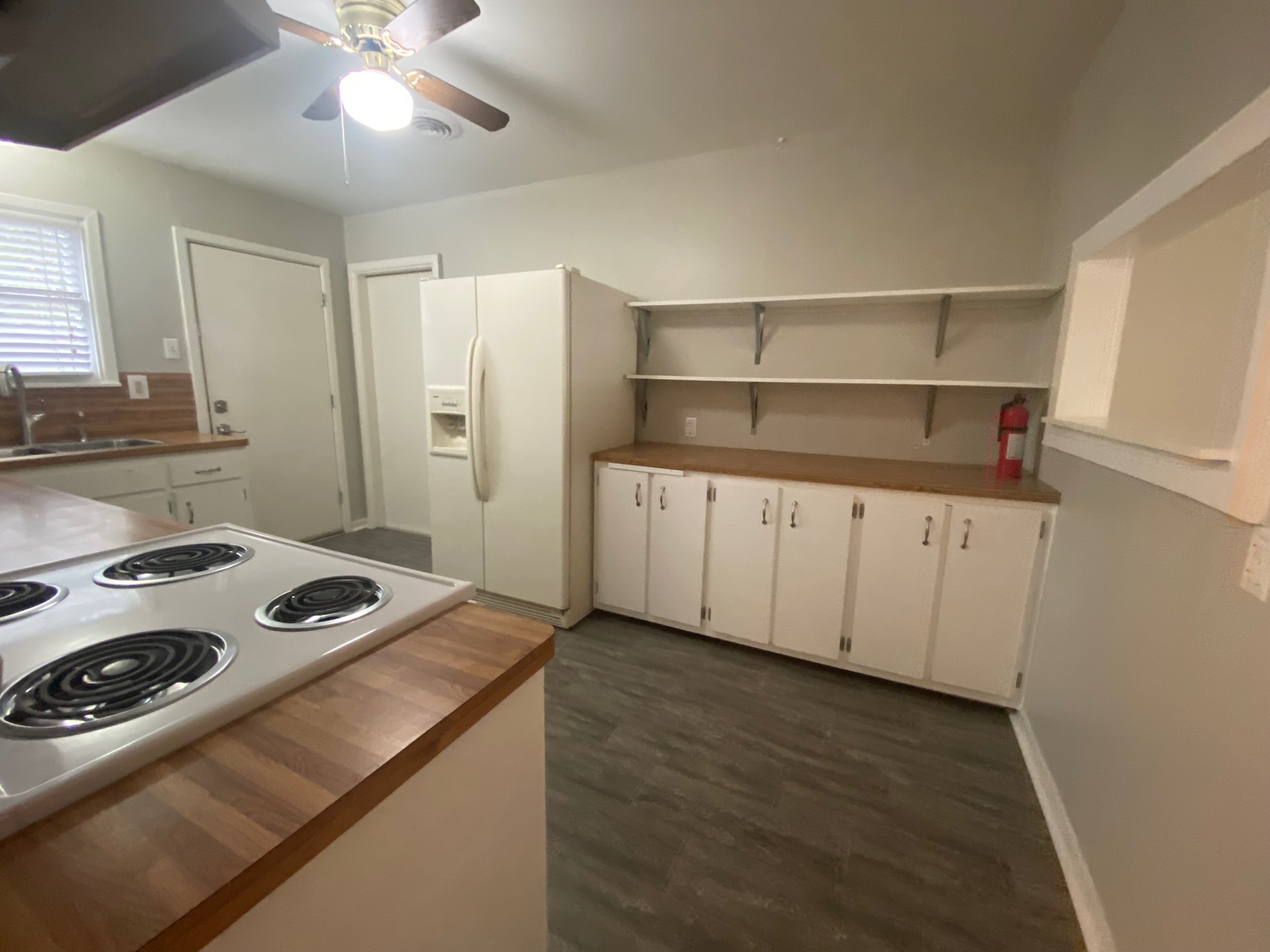 1818 South 39th Street Temple, TX 76504 - Photo 4 of 14 Kitchen with white cabinetry, white appliances, ceiling fan, dark wood-type flooring, and open shelves