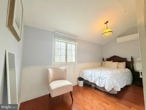 a bedroom with a bed lamps and a window