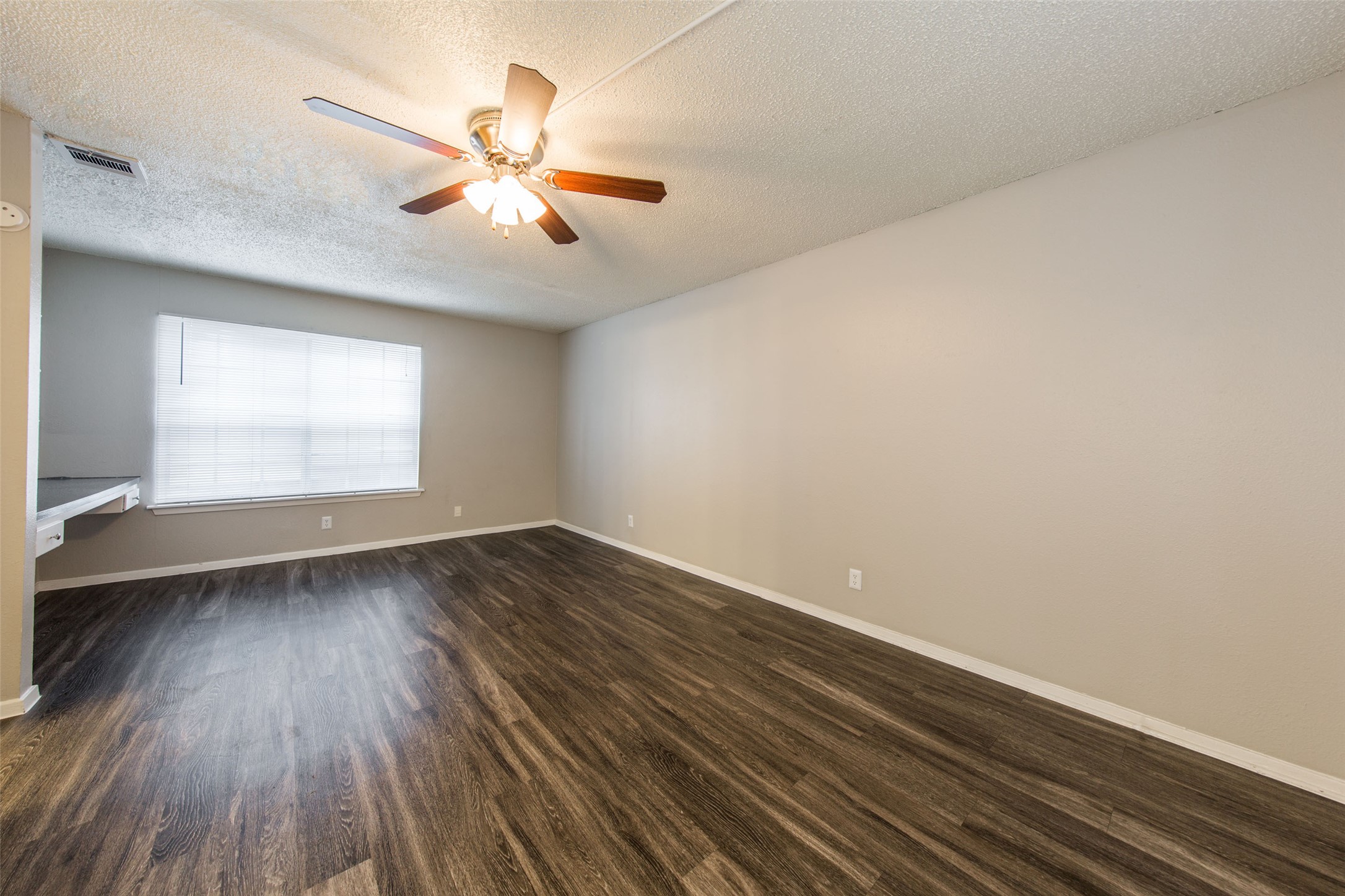 3101 Tom Green Street, Unit 104 Austin, TX 78705 - Photo 4 of 9 wooden floor in an empty room with a window