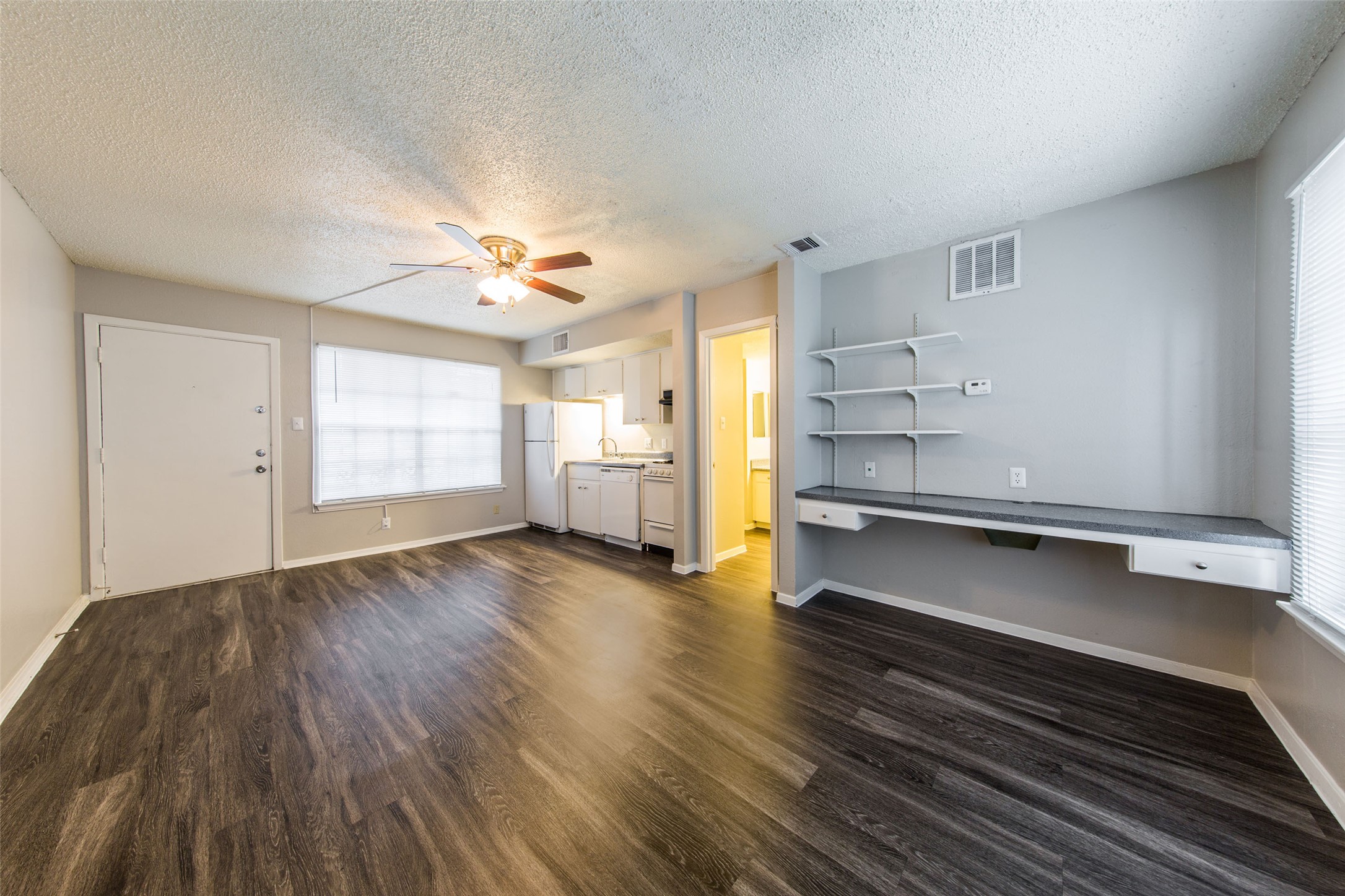 3101 Tom Green Street, Unit 104 Austin, TX 78705 - Photo 5 of 9 a view of empty room with wooden floor and fan
