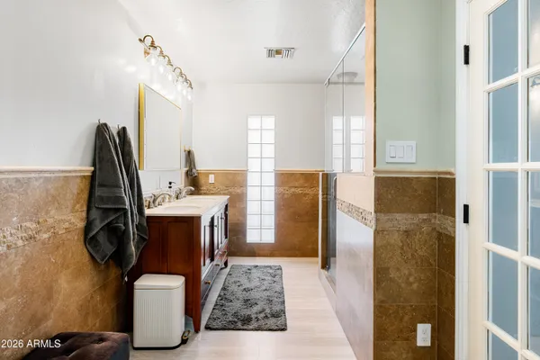a bathroom with a sink double vanity and shower