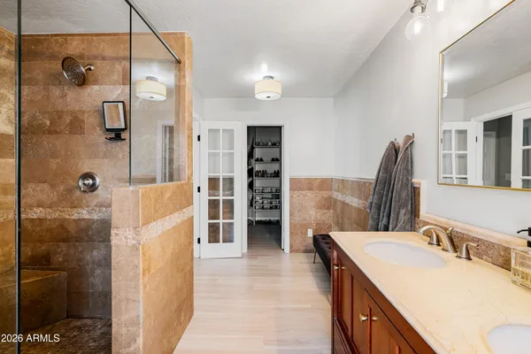 a view of walk in closet with clothes and shoes