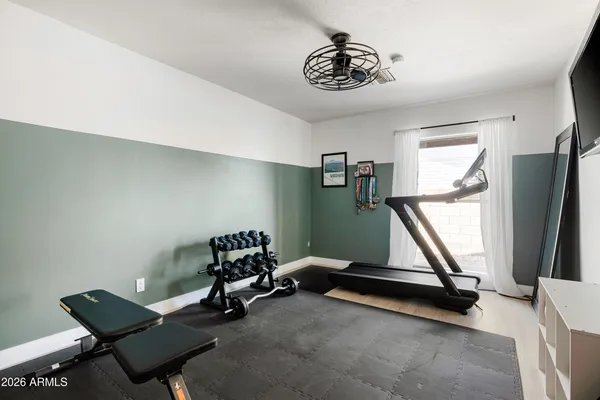 a bedroom with bed and a mirror