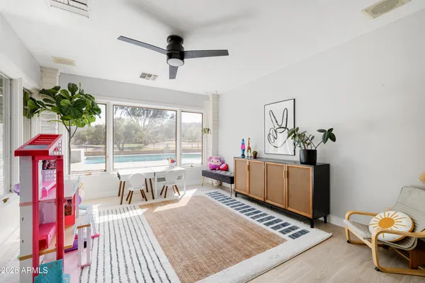 a living room with furniture and flowers