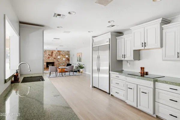 a kitchen with white cabinets and stainless steel appliances
