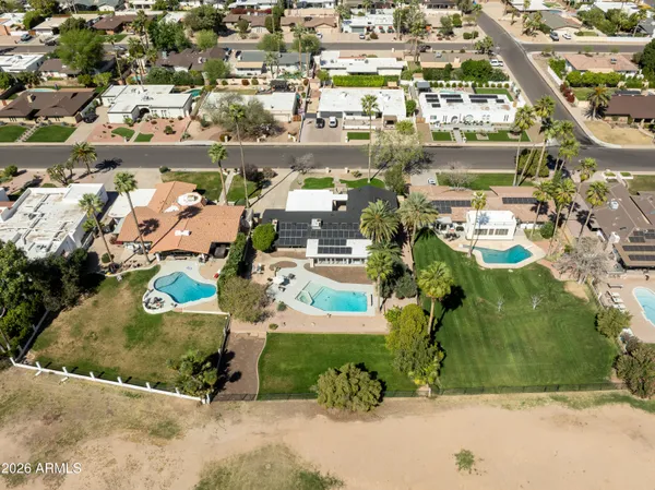 an aerial view of residential houses with outdoor space