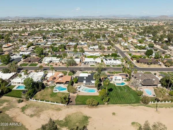 an aerial view of residential houses with outdoor space