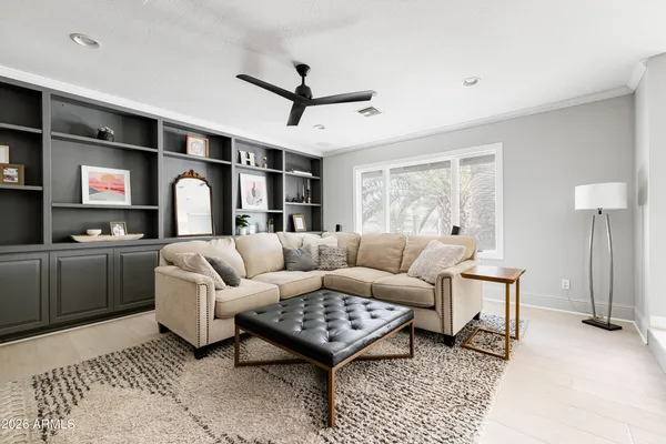 a living room with furniture ceiling fan and a rug