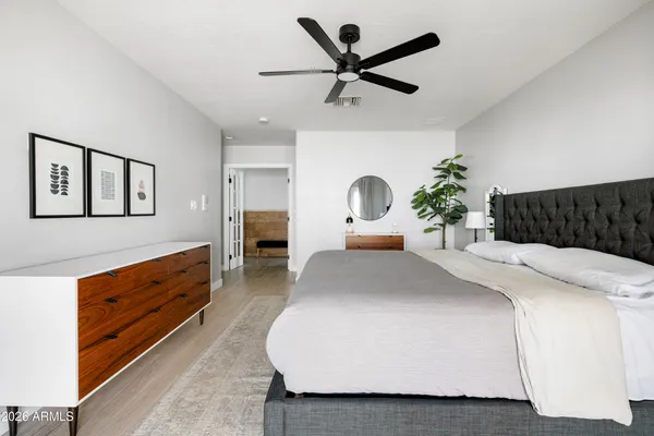 a bedroom with a large bed and a chandelier