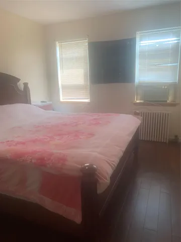 a bedroom with a bed and window