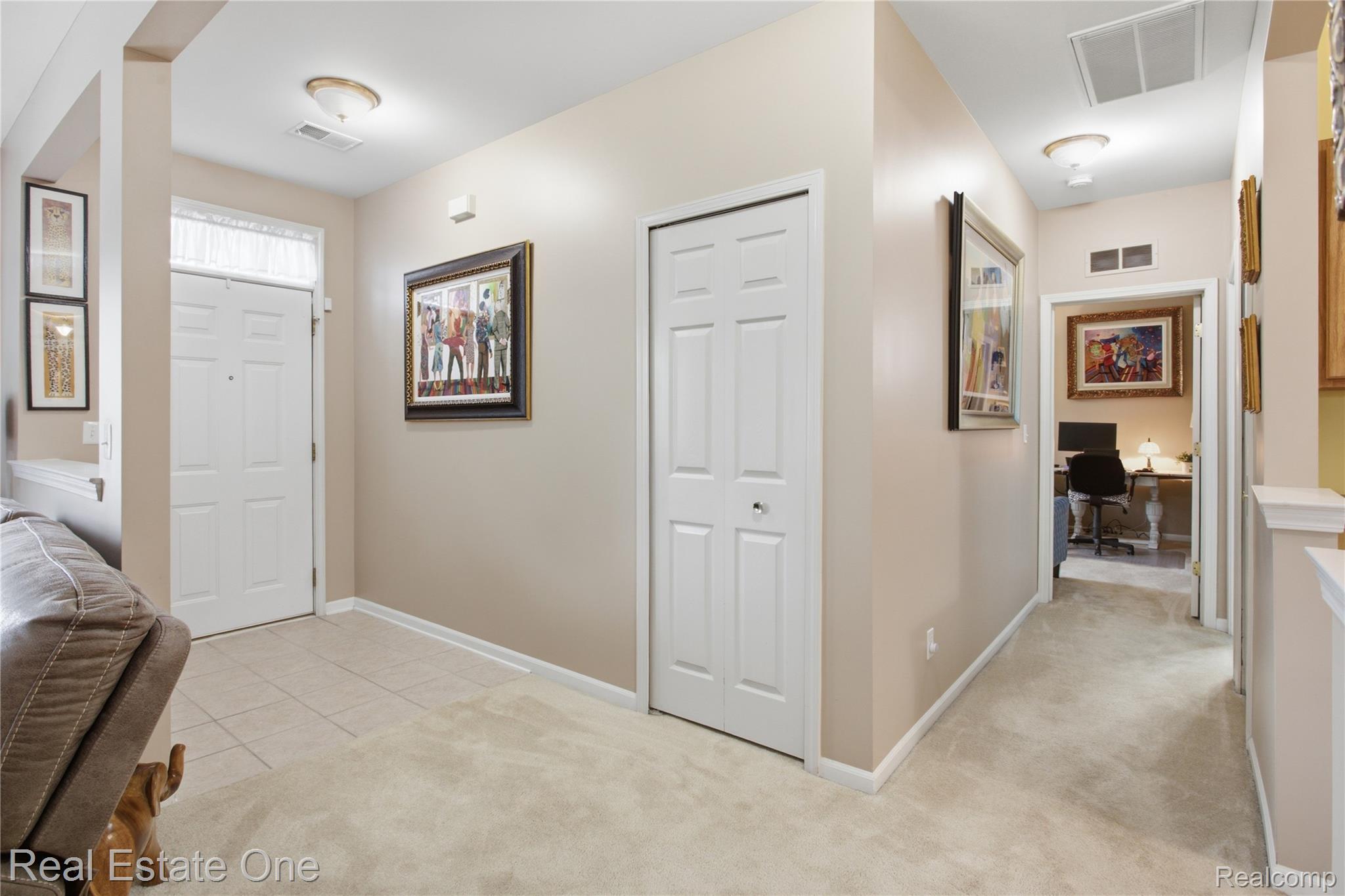 1828 Flagstone Circle, Unit 40 Rochester, MI 48307 - Photo 9 of 22 Entryway featuring a white paneled front door with a transom window, tile flooring, and overhead lighting