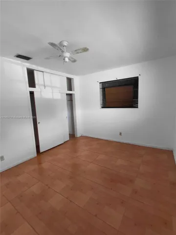 a view of a livingroom with an empty space and a ceiling fan