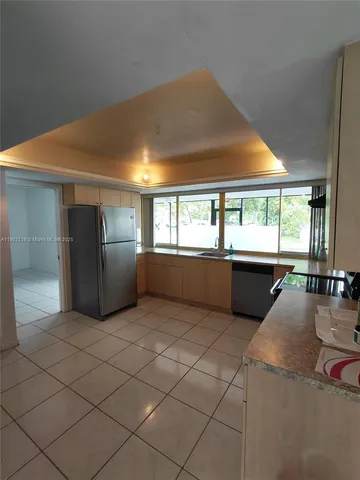 a view of a kitchen with furniture and windows