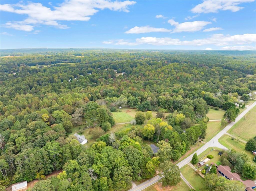 6668 Belton Bridge Road Lula, GA 30554 - Photo 11 of 20 a view of a city with lush green forest
