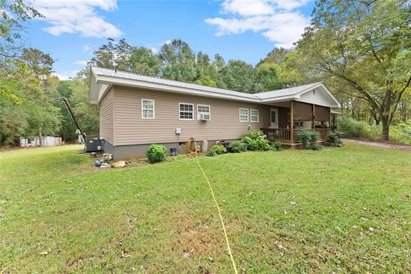 a backyard of a house with plants and garden