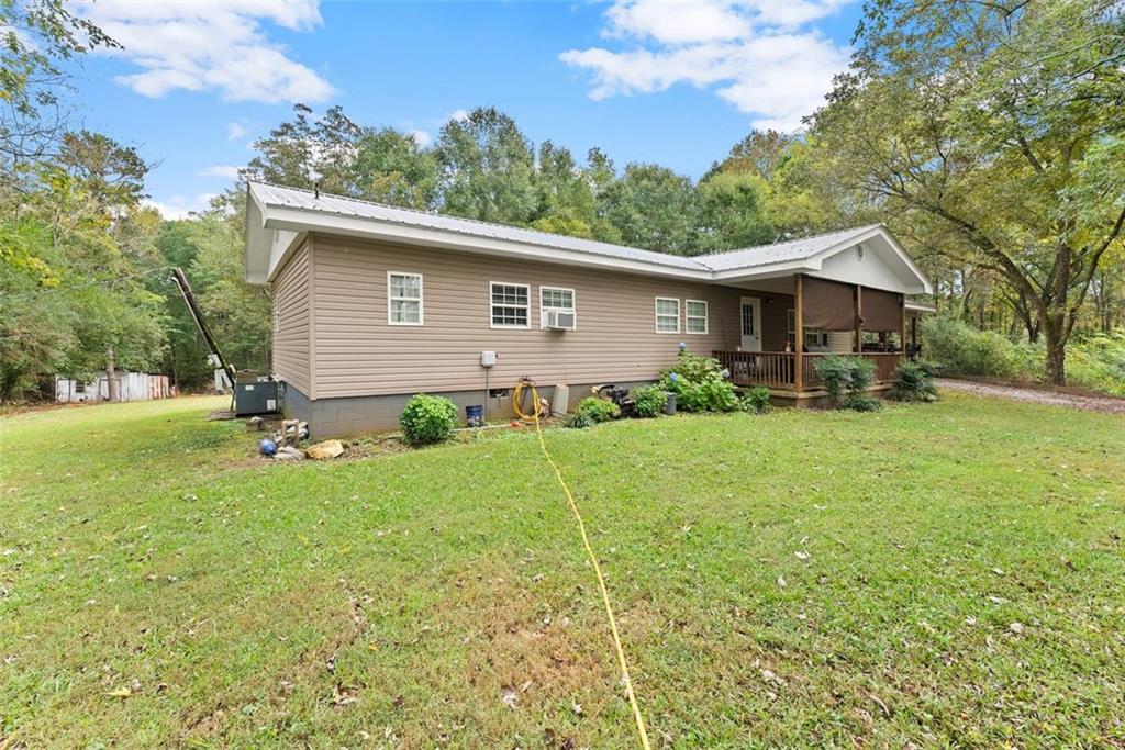 6668 Belton Bridge Road Lula, GA 30554 - Photo 3 of 20 a backyard of a house with plants and garden