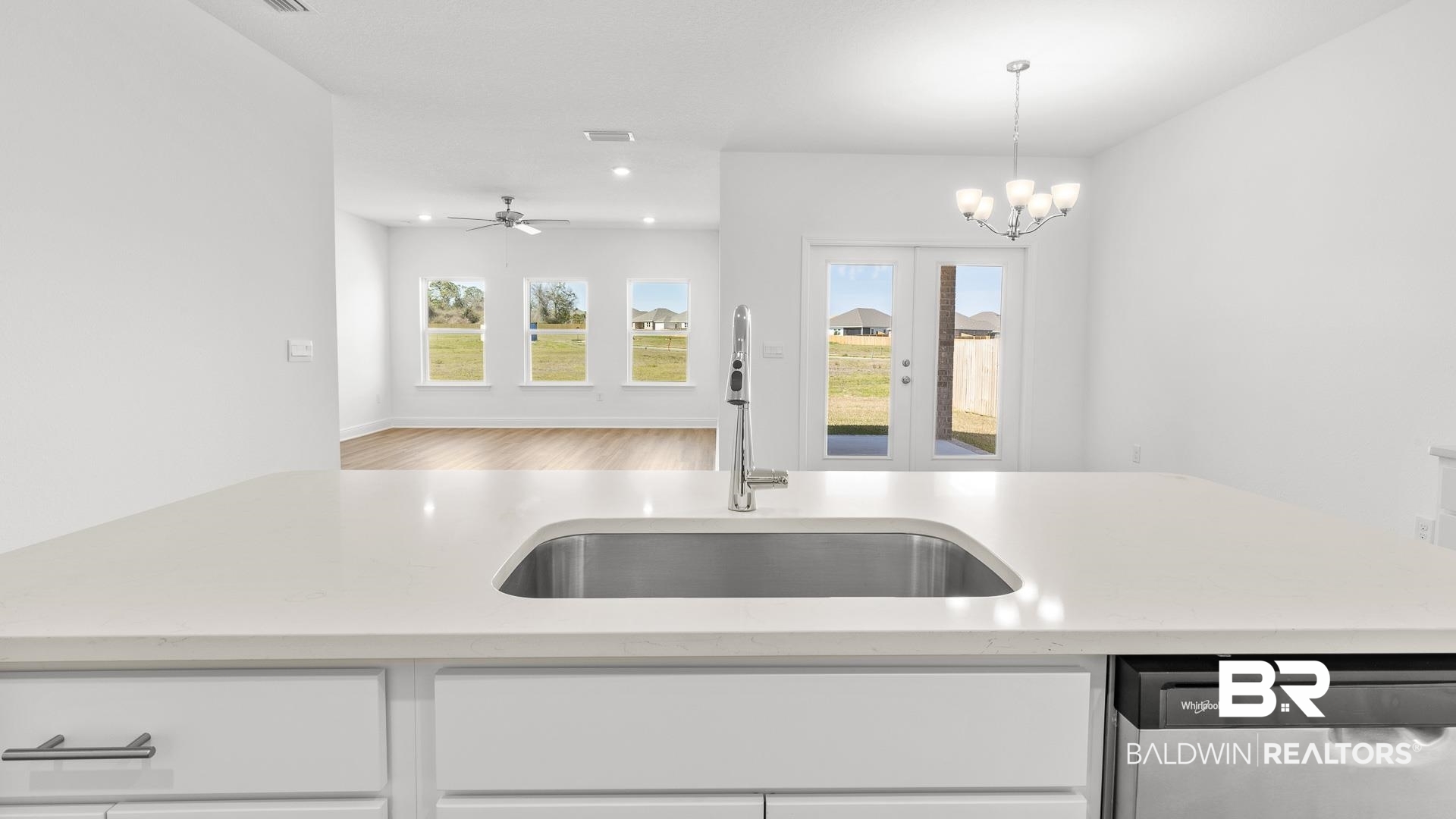 12931 Grand Rpds Road Fairhope, AL 36532 - Photo 33 of 33 Kitchen featuring a sink, stainless steel dishwasher, open floor plan, and light countertops
