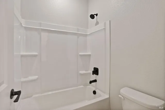 a bathroom with a bathtub and shower