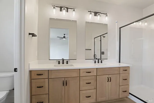 a bathroom with a double vanity sink mirror and