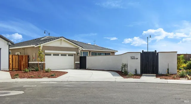 a view of a house next to a yard