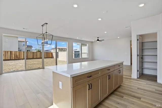 a kitchen with a stove and a wooden floors