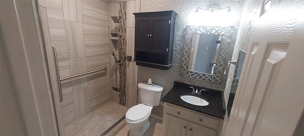 4102 Midrose Trail Dallas, TX 75287 - Photo 14 of 16 a bathroom with a toilet a sink and a shower