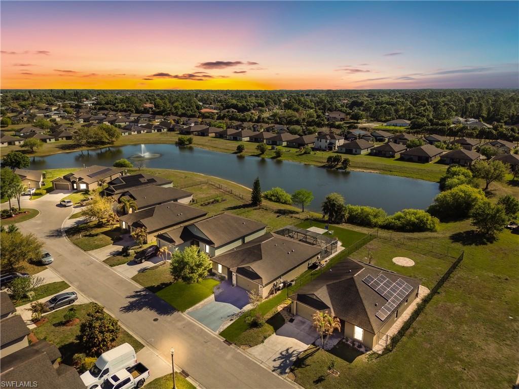 175 Shadowview Court Lehigh Acres, FL 33974 - Photo 34 of 39 an aerial view of a house with a lake view