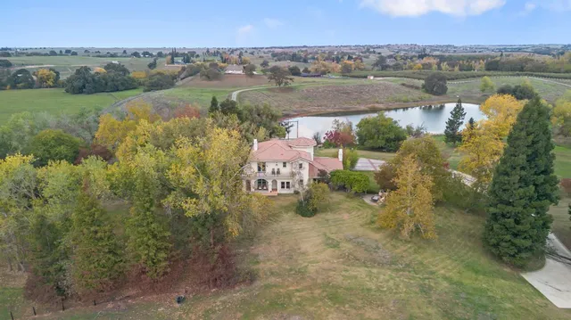 a living room with furniture a fireplace and a floor to ceiling window
