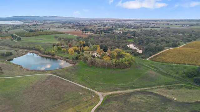 a living room with furniture a table and kitchen chandelier