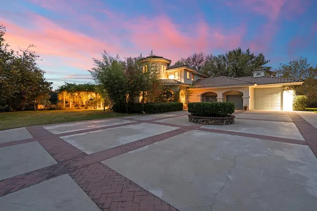 a front view of a house with a yard and a garage