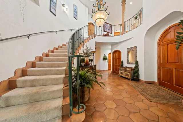 a living room with furniture a fireplace and a large window
