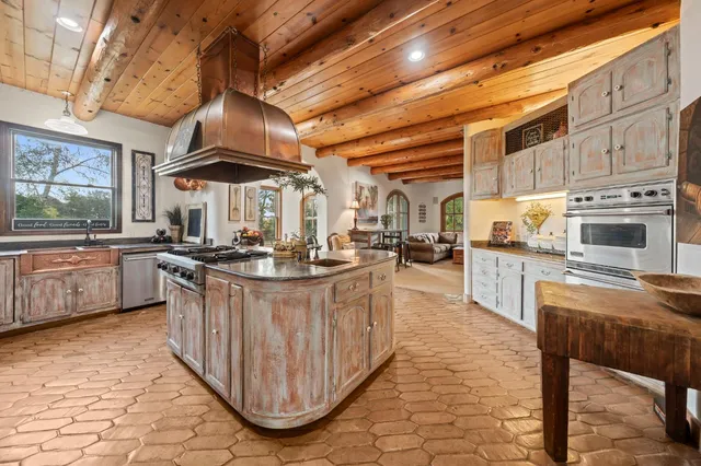 a view of a white house with a big yard and large trees