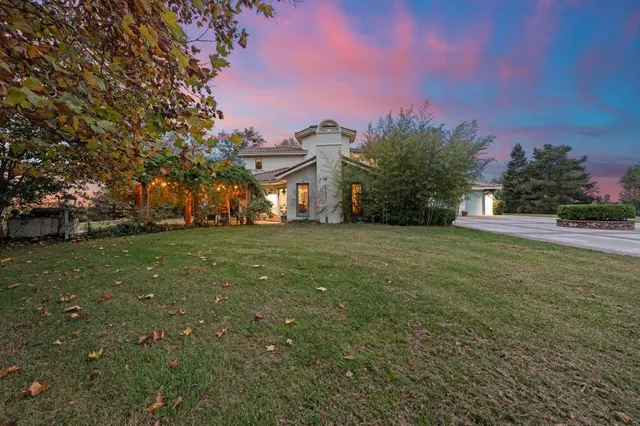 an aerial view of residential houses with outdoor space and lake view