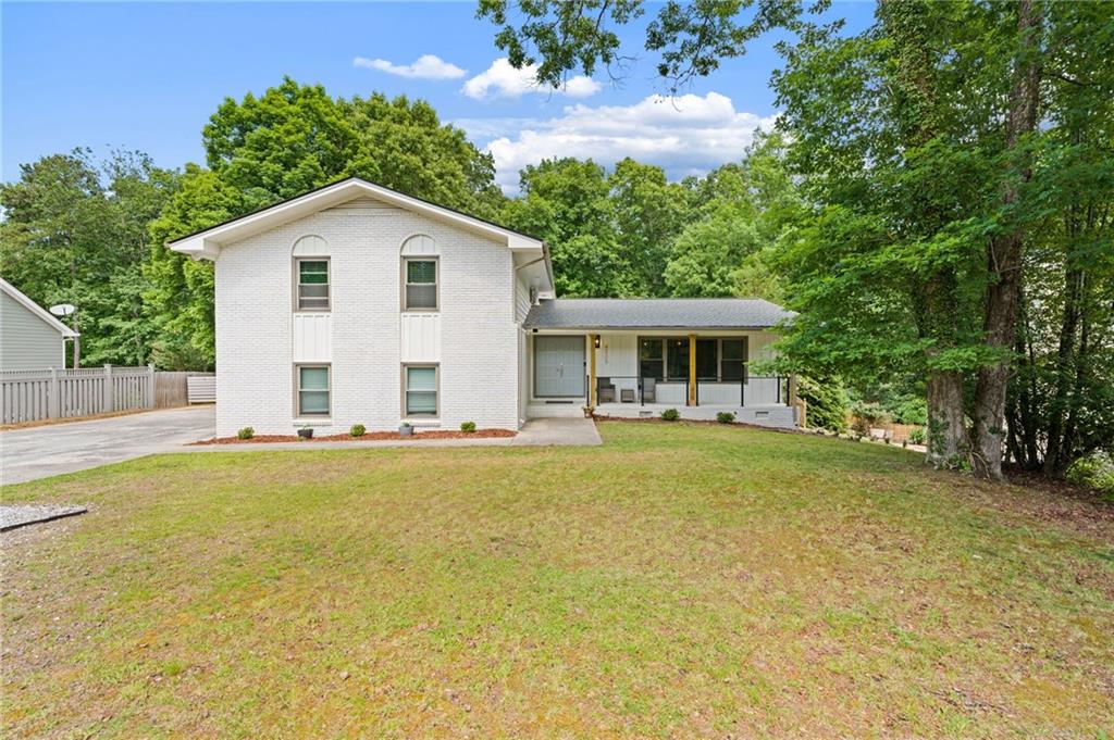 4205 South Berkeley Lake Road Northwest Berkeley Lake, GA 30096 - Photo 23 of 34 a view of a house with pool and chairs