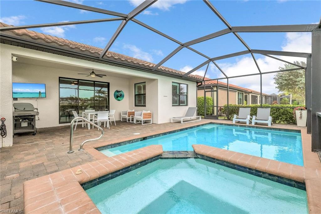 1603 Santiago Circle Naples, FL 34113 - Photo 26 of 46 a view of a backyard with swimming pool table and chairs