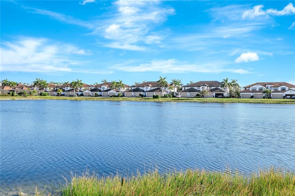 1603 Santiago Circle Naples, FL 34113 - Photo 31 of 46 a view of a lake with houses