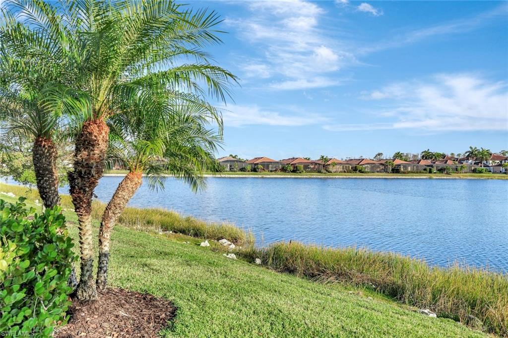 1603 Santiago Circle Naples, FL 34113 - Photo 32 of 46 a view of a lake with houses in the back