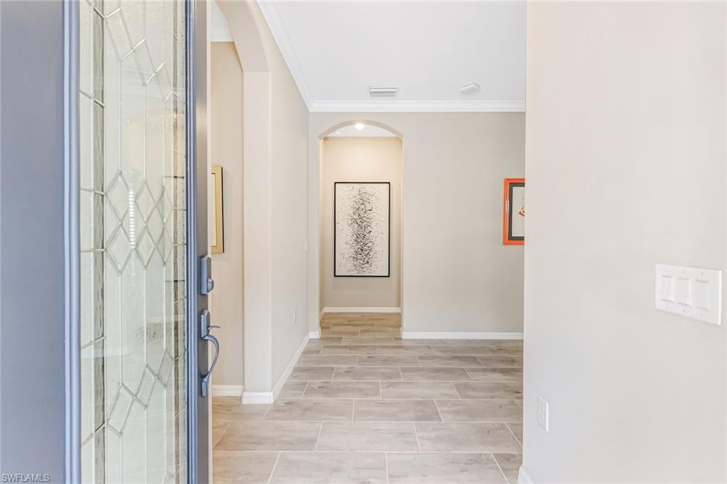 1603 Santiago Circle Naples, FL 34113 - Photo 4 of 46 a view of a hallway with wooden floor