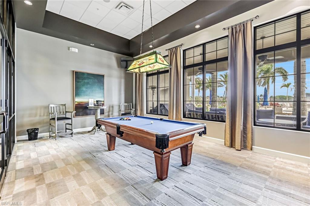 1603 Santiago Circle Naples, FL 34113 - Photo 42 of 46 a living room with furniture a large window and wooden floor