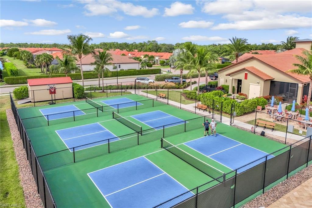 1603 Santiago Circle Naples, FL 34113 - Photo 44 of 46 a view of a chairs and table in the backyard