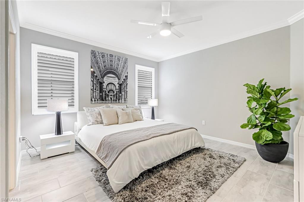 1603 Santiago Circle Naples, FL 34113 - Photo 6 of 46 a bedroom with a large bed and a couch