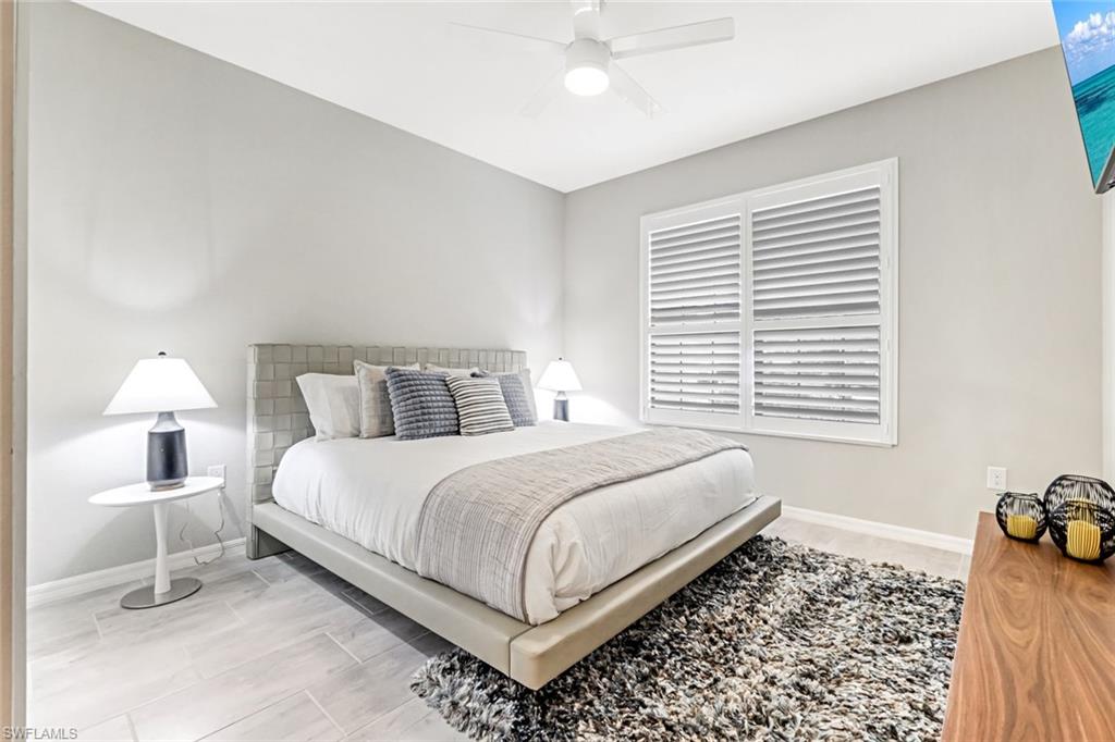 1603 Santiago Circle Naples, FL 34113 - Photo 9 of 46 a bedroom with a bed and a window