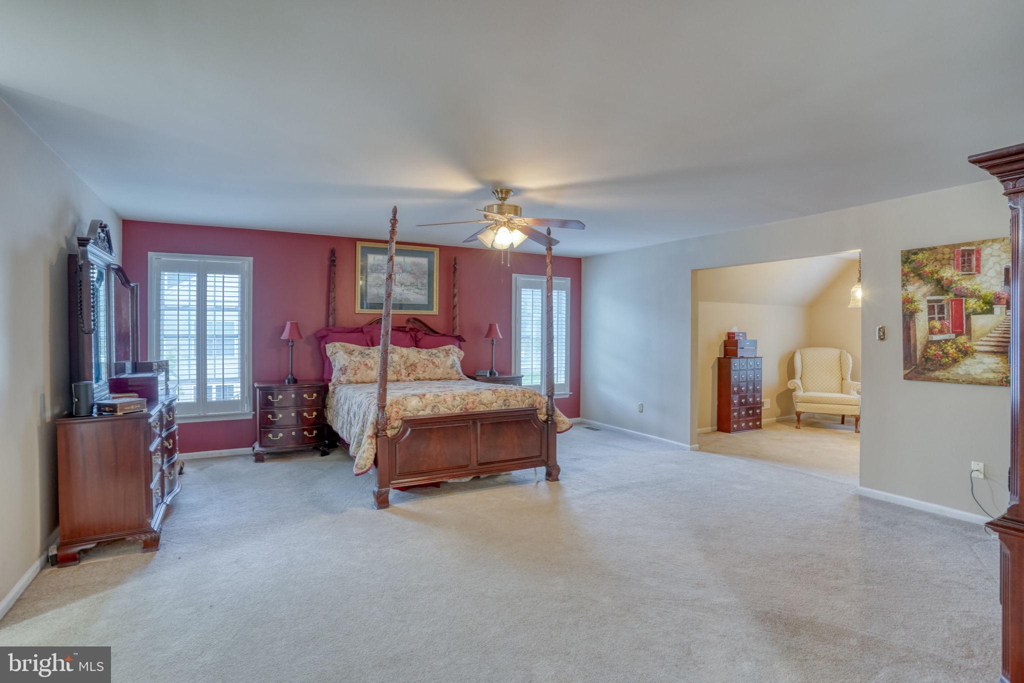 357 Willits Way Garnet Valley, PA 19060 - Photo 33 of 63 a spacious bedroom with a bed and a chandelier