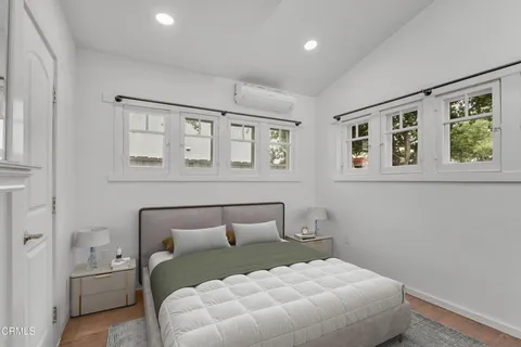 a bedroom with a large bed and a window