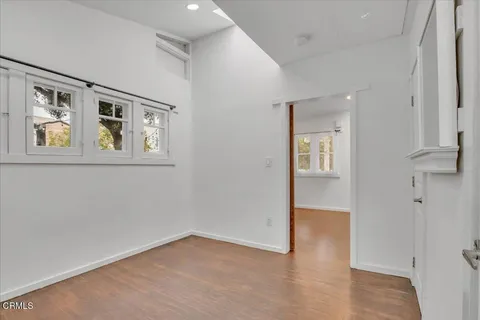 an empty room with windows and closet